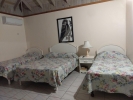 Кровать или кровати в номере Shields Negril Villas LTD