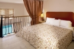 Кровать или кровати в номере Mitsis Family Village Beach Hotel