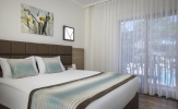 Кровать или кровати в номере Kimeros Park Holiday Village - Ultra All Inclusive