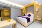 Кровать или кровати в номере Quest Hotel Kuta
