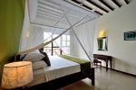 Кровать или кровати в номере Amaan Beach Bungalows