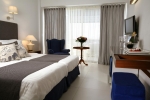 Кровать или кровати в номере Aquila Porto Rethymno