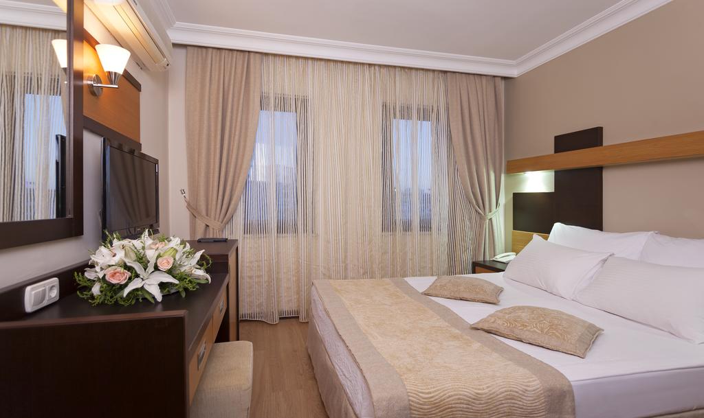 Отель Кровать или кровати в номере Kandelor Hotel