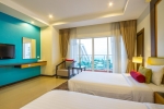 Кровать или кровати в номере Prima Wongamat Hotel