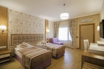 Кровать или кровати в номере Kustur Club Holiday Village - All Inclusive