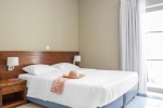 Кровать или кровати в номере Neptuno Beach Hotel