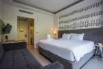 Кровать или кровати в номере The Melody Phuket
