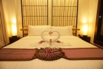 Кровать или кровати в номере Bamboo House Phuket