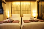 Кровать или кровати в номере Bamboo House Phuket