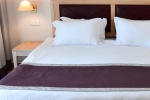 Кровать или кровати в номере Curium Palace Hotel