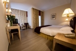 Кровать или кровати в номере Curium Palace Hotel