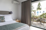 Кровать или кровати в номере Mitsis Rinela Beach Resort & Spa