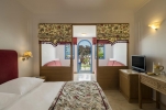 Кровать или кровати в номере Mitsis Rinela Beach Resort & Spa