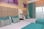 Кровать или кровати в номере Asia Beach Resort & Spa Hotel