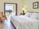 Кровать или кровати в номере Grecotel Olympia Oasis & Aqua Park