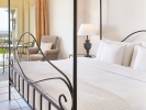 Кровать или кровати в номере Grecotel Olympia Oasis & Aqua Park