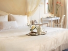 Кровать или кровати в номере Grecotel Eva Palace