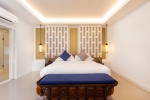 Кровать или кровати в номере Manathai Surin Phuket