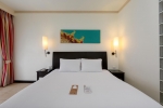 Кровать или кровати в номере Centara Kata Resort Phuket
