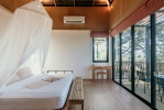 Кровать или кровати в номере The Mangrove Panwa Phuket Resort