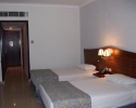 Кровать или кровати в номере Stella Di Mare Gardens Resort & Spa