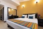 Кровать или кровати в номере Citrus Hikkaduwa