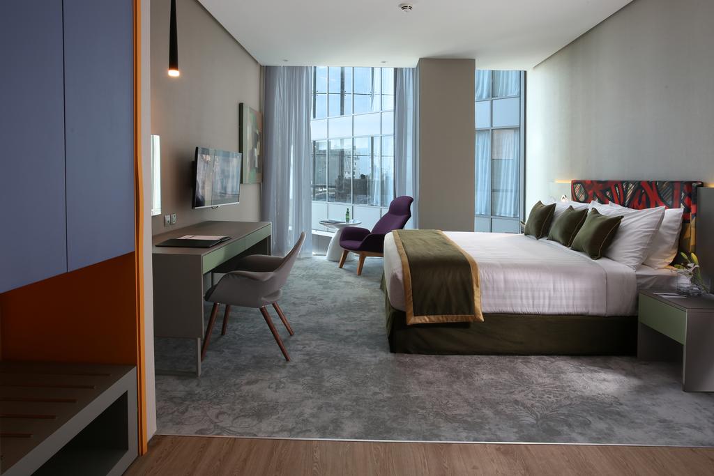 Кровать или кровати в номере Ibis Styles Dubai Jumeira