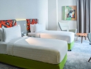 Кровать или кровати в номере Ibis Styles Dubai Jumeira