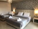 Кровать или кровати в номере Garden Palace Hotel