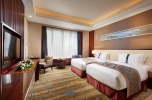 A bed or beds in a room at Beijing Hotel Minsk