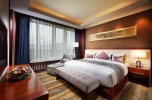 A bed or beds in a room at Beijing Hotel Minsk