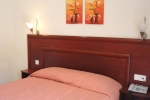 Кровать или кровати в номере Xenios Loutra Village Beach Hotel