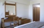 Кровать или кровати в номере Mitsis Petit Palais Beach Hotel