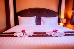 Кровать или кровати в номере New Nordic Hotel Pattaya