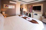 Кровать или кровати в номере New Nordic Hotel Pattaya
