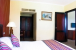 Кровать или кровати в номере Parrotel Aqua Park Resort