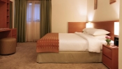 Кровать или кровати в номере Ramada Hotel & Suites by Wyndham Ajman