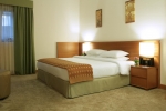 Кровать или кровати в номере Ramada Hotel & Suites by Wyndham Ajman