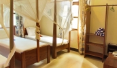 Кровать или кровати в номере Mnarani Beach Cottages