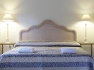 Кровать или кровати в номере Grecotel Plaza Spa Apartments