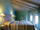 Кровать или кровати в номере Grecotel Plaza Spa Apartments