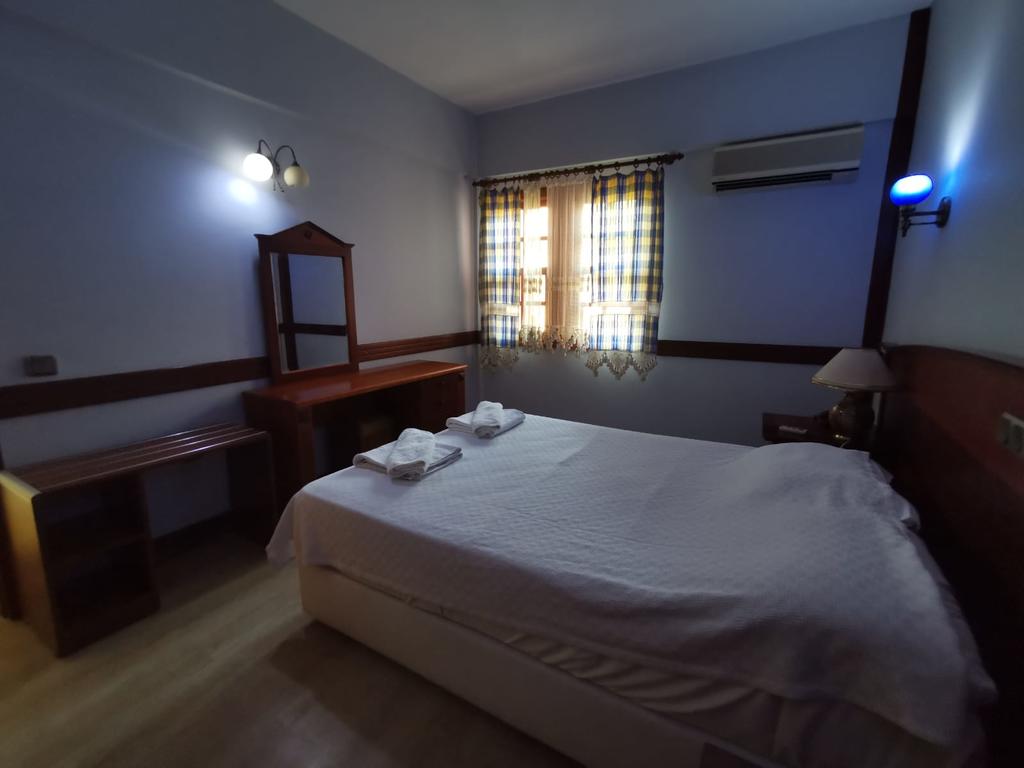 Отель Кровать или кровати в номере Club Pink Palace Hotel